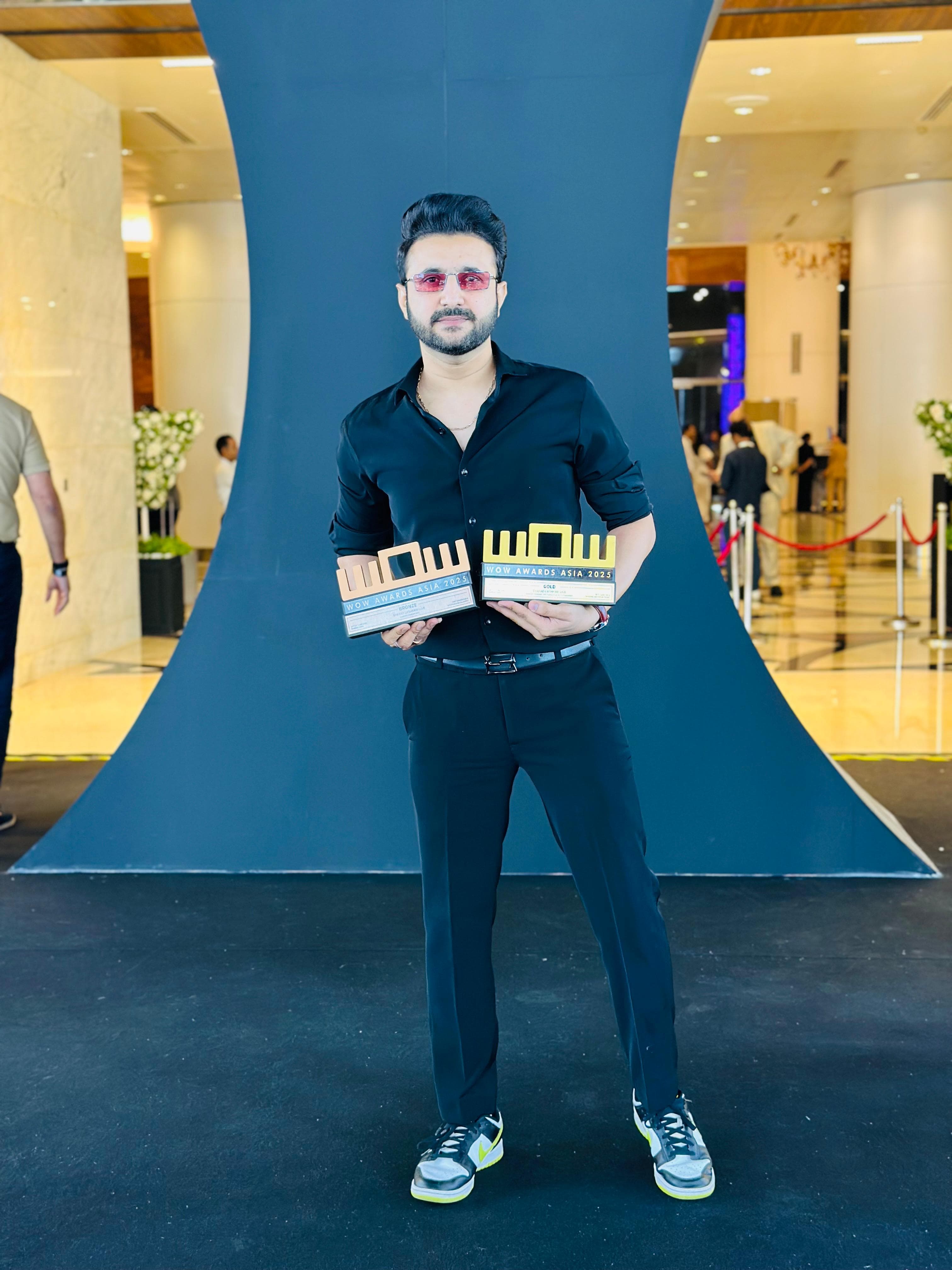 Sharad Lashkari standing with the WOW Awards Asia 2025 awards